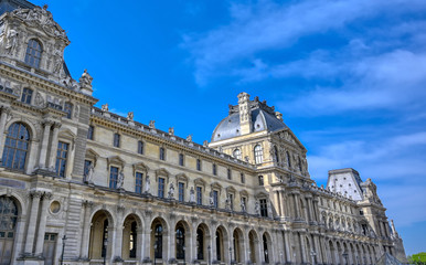 Fototapeta na wymiar Paris, France - April 21, 2019 - A view of the Louvre Museum, the world's largest art museum and a historic monument in Paris, France, on a sunny day.