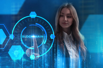 The concept of business, technology, the Internet and the network. A young entrepreneur working on a virtual screen of the future and sees the inscription: Blockchain