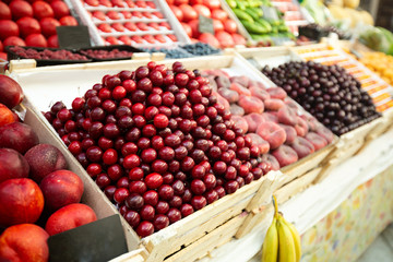 A lot of cherries in box on sale at farms market