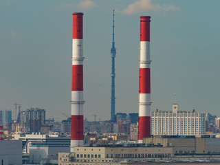 Obraz premium View from above of Moscow city. Heat station pipes, House of the Government of the Russian Federation (Russian White House), high spire of Ostankino tv tower in summer 