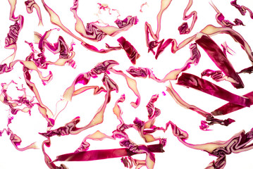 Texture of red cabbage (Brassica oleracea) cut and falling. Isolated on white background.