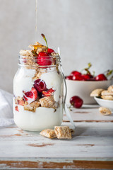 Bitesize shredded wheat with fresh cherry berries in Jar