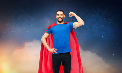Fototapeta na wymiar power and people concept - happy man in red superhero cape over night sky background