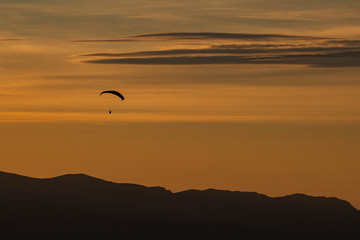 Fototapeta na wymiar Sunset and paraglider