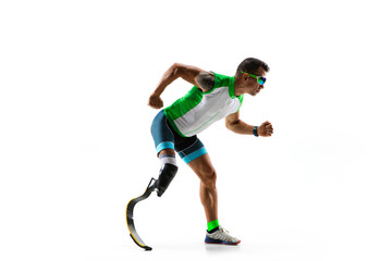 Athlete with disabilities or amputee isolated on white studio background. Professional male runner with leg prosthesis training and practicing in studio. Disabled sport and healthy lifestyle concept.