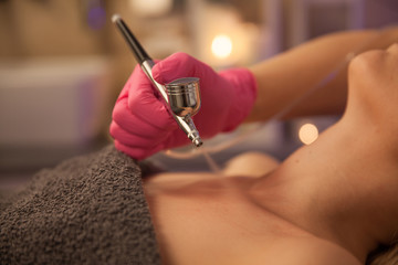 Oxygen dermapen therapy. Woman doing body treatment in beauty spa salon. 