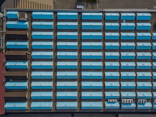 Aerial view of roof of industry building with regular pattern of windows