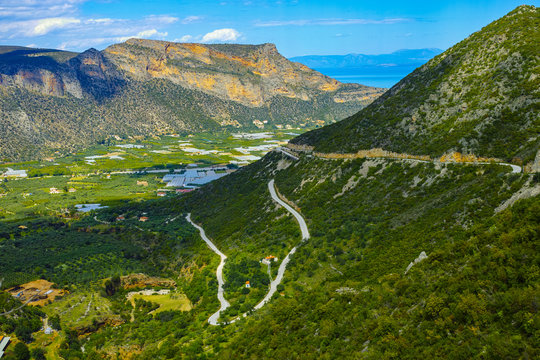 View on fertile valley near Leonidio, Peloponnese, Greece with ancient town, fields and orchards