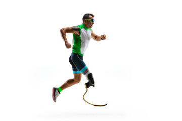 Obraz premium Athlete with disabilities or amputee isolated on white studio background. Professional male runner with leg prosthesis training and practicing in studio. Disabled sport and healthy lifestyle concept.