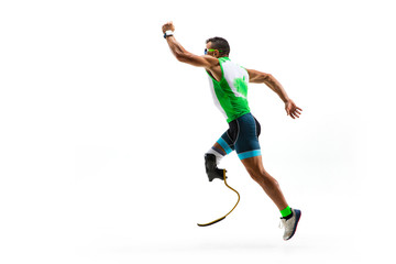 Athlete with disabilities or amputee isolated on white studio background. Professional male runner with leg prosthesis training and practicing in studio. Disabled sport and healthy lifestyle concept.