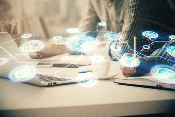 Social network theme hologram with businessman working on computer on background. Concept of world...