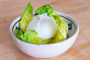 Burrata, typical cheese of Puglia served in a traditional ceramic bowl