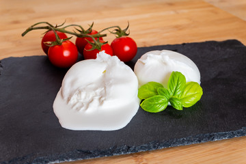 Composition of tomatos, basil and burrata cheese handmade in Puglia, Italy