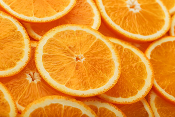 Round orange slices, in the form of texture and lanterns of fresh juicy slices