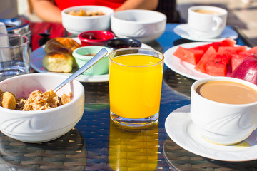 Cacao, juice, muesli and fruits for breakfast at a cafe in the resort