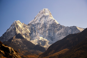 Ama Dablam massif against the blue sky in the morning.