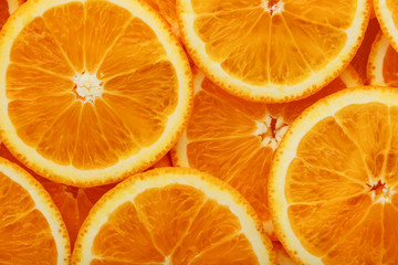 Round orange slices, in the form of texture and lanterns of fresh juicy slices