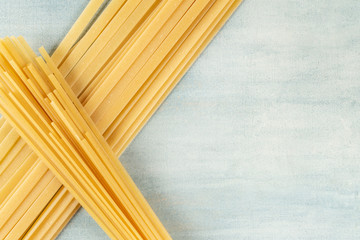 Crossing of Italian flat pastas. Minimalist pasta background with strong graphic composition