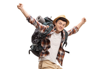 Naklejka premium Young male backpacker jumping and gesturing happiness