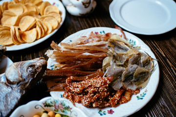smoked fish, snacks on a wooden table