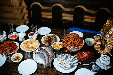 Obraz na płótnie Canvas boiled crayfish, salted fish, snacks on a wooden table