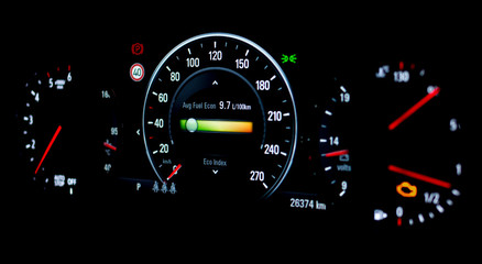 Side view of modern car dashboard with speedometer, tachometer, odometer, car's temperature gauge...