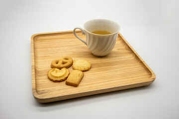 Homemade cookie and tea on wooden tray isolated on white