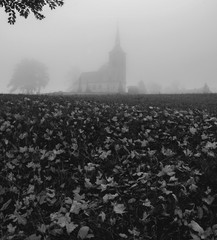 Black and white church in the fog 
