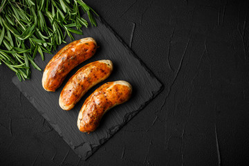 sausage fried with herbs and spices. on the black board