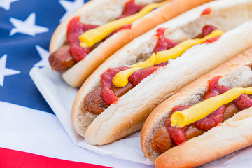 Typical american fastfood: hot dogs and american flag. Close-up view of stereotypical US food