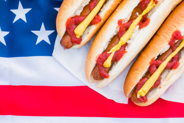 Typical american fastfood: hot dogs and american flag. Close-up view of stereotypical US street food