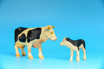 Toy animals made of plastic on a blue background, baby little animals.