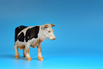Toy animals made of plastic on a blue background, baby little animals.