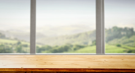 Table background with wooden top board with nice forest and gardens view in distance. Happy barbecue or picnic time with family. Empty space on the table top for an advertising product..