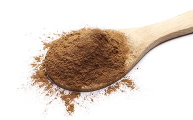 Ground cinnamon powder with wooden spoon isolated on white background