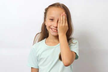 Fototapeta premium little cute cheerful girl passes an eye test in the office of an ophthalmologist