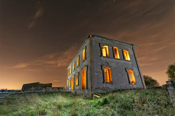 Abandoned station with light inside under a cold night