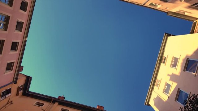 Verticle view of spinning apartment buildings giving a dizzying effect