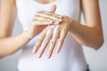 Woman applying hand cream - stock photo