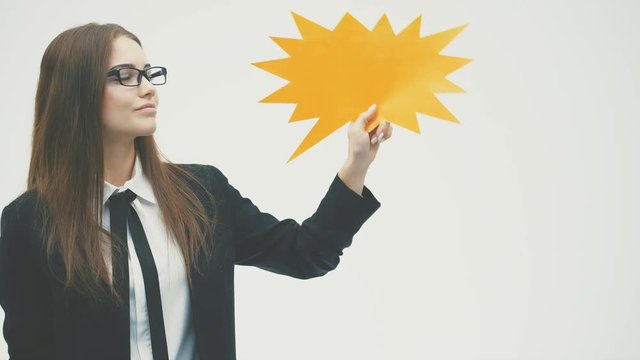 Young beautiful girl holding a yellow bubble for text, isolated on a white background.