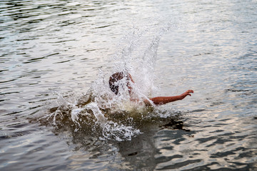 Obraz premium boy swims in the river