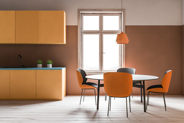 Orange kitchen interior with countertops and table