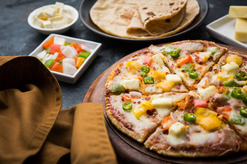 Chapati Pizza made using leftover Roti / Paratha with Cheese, vegetables, paneer and Sausage