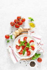 Fresh italian Caprese salad on white plate, view from above