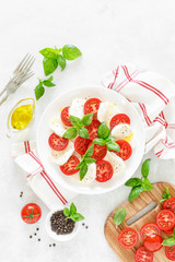 Fresh italian Caprese salad on white plate, view from above