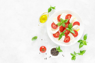 Fresh italian Caprese salad on white plate, view from above