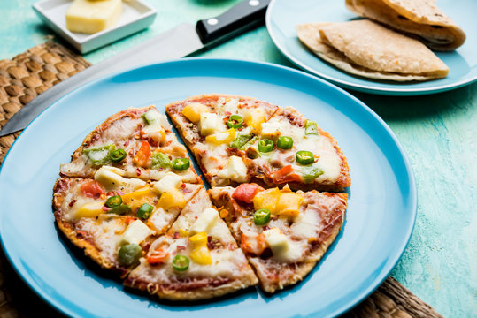 Chapati Pizza made using leftover Roti / Paratha with Cheese, vegetables, paneer and Sausage
