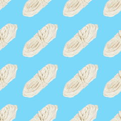 Seamless pattern of a skein of white rope on blue background