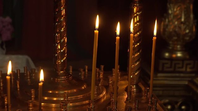 candles are lit on the candlestick in the church