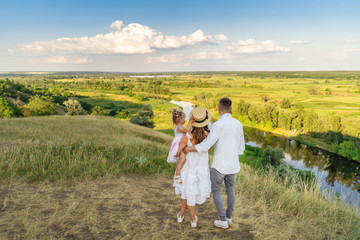 Family of three people looking to beautiful landscape